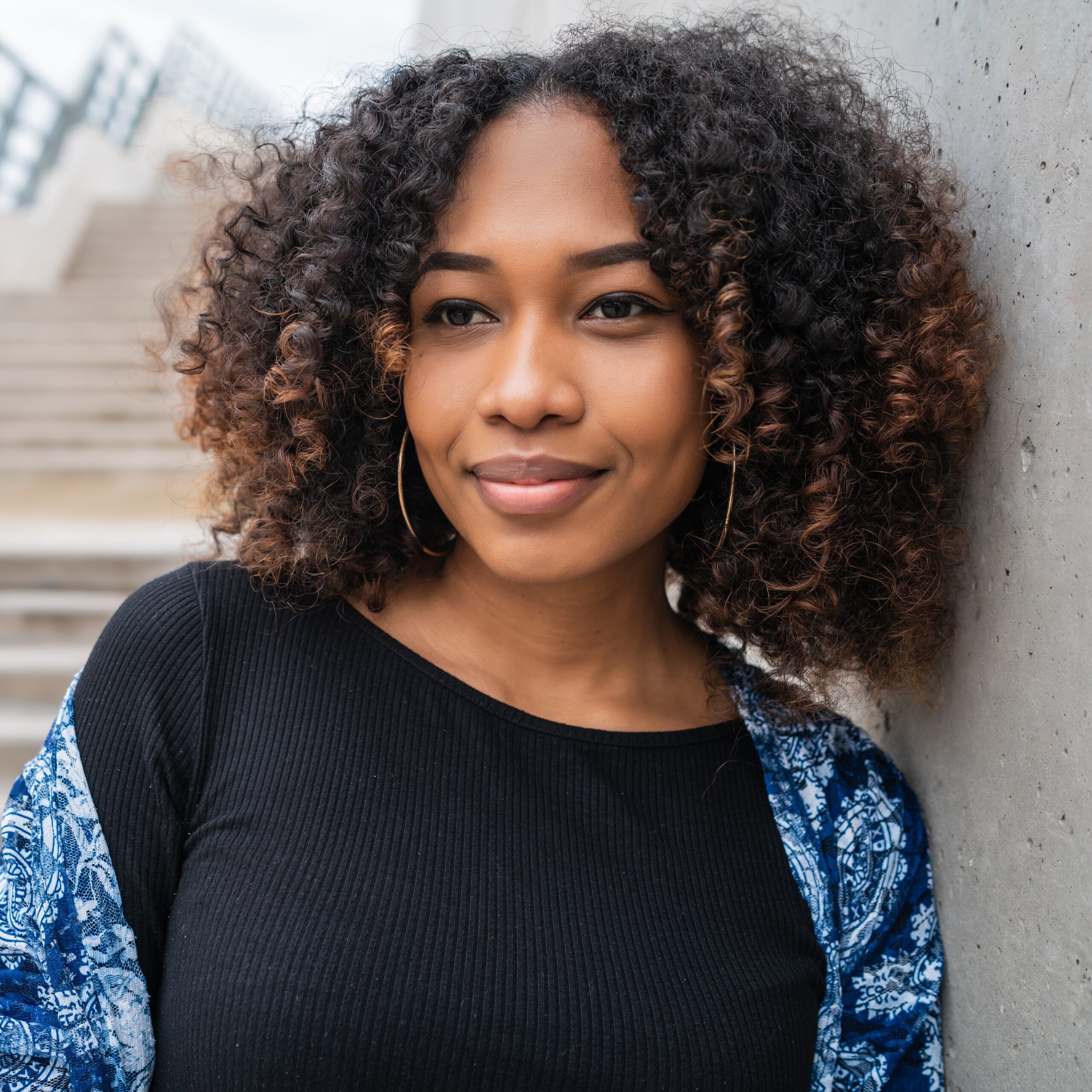 A woman smiling because she knows Pathway of Hope offers free pregnancy services and support in Philadelphia, Pennsylvania